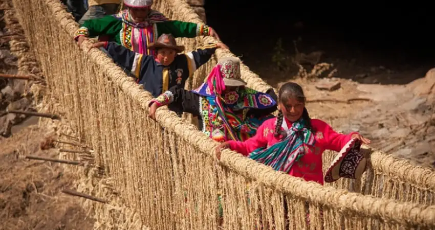 people crossing the Qeswachaca Bridge