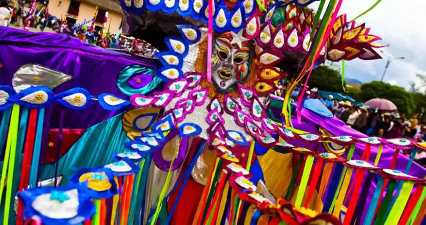 Colorful carnival masks displayed during the Cajamarca parade in Peru, showcasing vibrant designs and festive spirit.