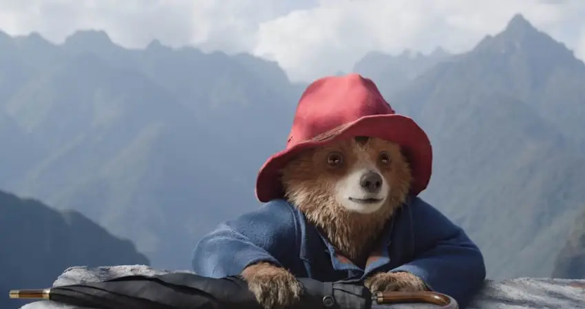 A scene from Paddington 3 trailer featuring Paddington Bear exploring the vibrant landscapes of Peru.